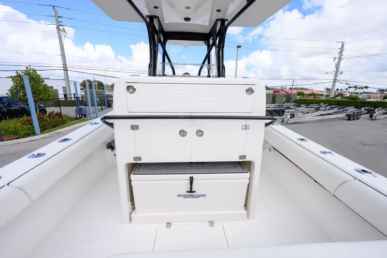  Yacht Photos Pics 2025 SeaVee 290B boat interior with storage compartments and seating, under a clear blue sky.