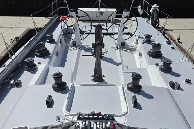 Peligroso Yacht Photos Pics Deck view of 2005 Dencho Marine Kernan 68 sailboat, featuring dual steering wheels and winches.