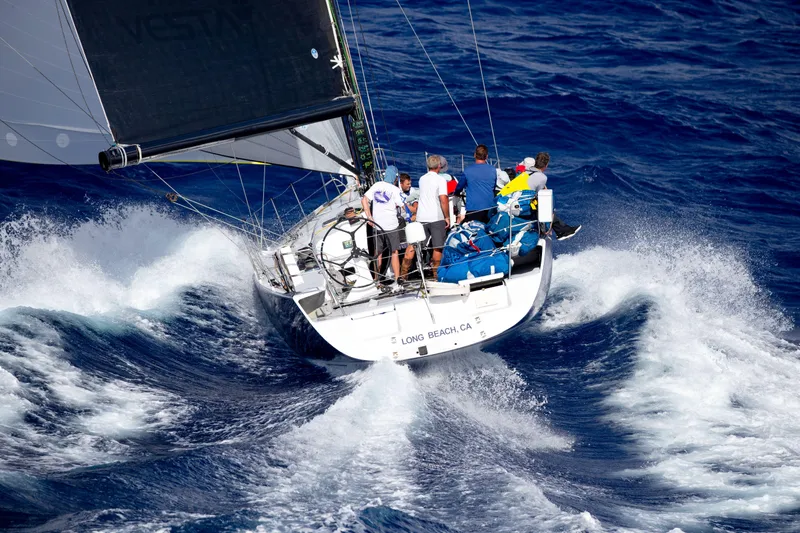 Peligroso Yacht Photos Pics Sailing yacht Dencho Marine Kernan 68, 2005, navigating through ocean waves with crew onboard.