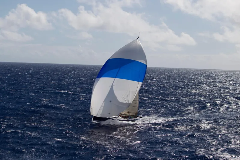 Peligroso Yacht Photos Pics Sailing yacht Dencho Marine Kernan 68, 2005, with blue and white spinnaker on open sea.