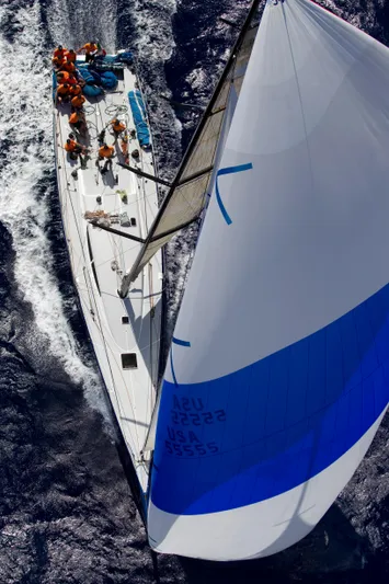 Peligroso Yacht Photos Pics Aerial view of Dencho Marine Kernan 68 sailboat, 2005 model, with crew on deck.