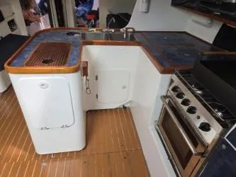 Peligroso Yacht Photos Pics Interior of 2005 Dencho Marine Kernan 68 yacht kitchen with stove and sink.