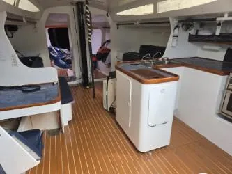 Peligroso Yacht Photos Pics Interior of 2005 Dencho Marine Kernan 68 yacht with modern kitchen and seating area.