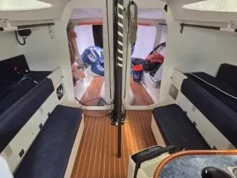 Peligroso Yacht Photos Pics Interior of 2005 Dencho Marine Kernan 68 sailboat with wooden flooring and seating.