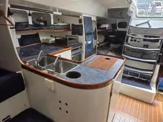 Peligroso Yacht Photos Pics Interior of 2005 Dencho Marine Kernan 68 yacht with kitchen and seating area.