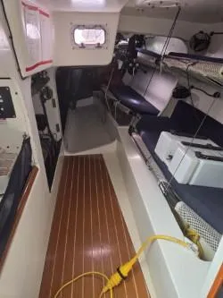 Peligroso Yacht Photos Pics Interior of 2005 Dencho Marine Kernan 68 sailboat with wooden flooring and seating.