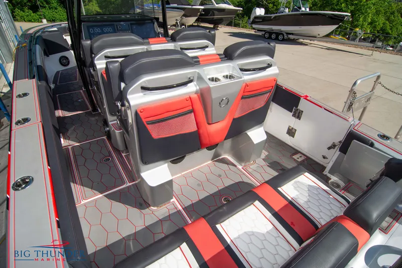  Yacht Photos Pics 2021 Fountain 38 SC boat interior with red and black seating, hexagonal floor pattern.