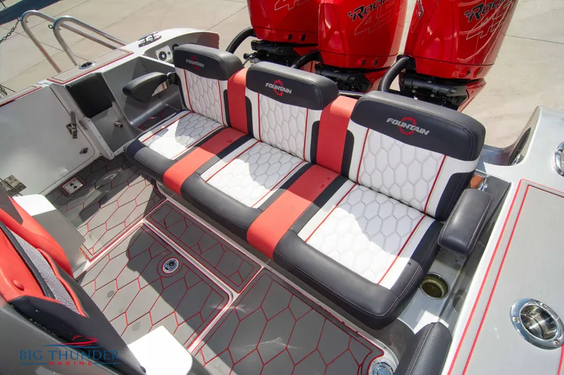  Yacht Photos Pics 2021 Fountain 38 SC boat interior with red and white seating and triple outboard engines.