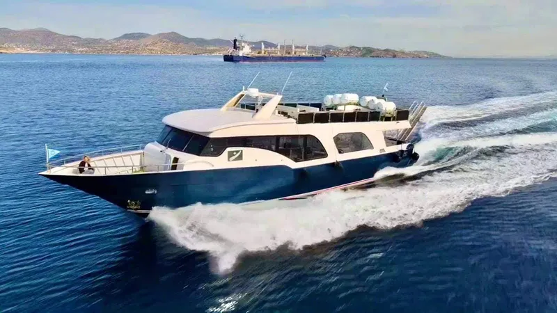  Yacht Photos Pics 2021 Jetcraft Passenger Boat cruising on open water, with distant ship and coastline.
