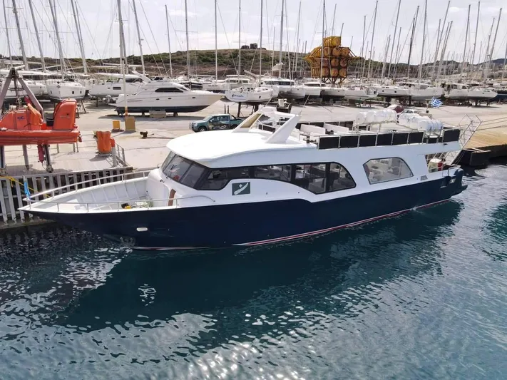  Yacht Photos Pics 2021 Jetcraft Passenger Boat docked at marina, surrounded by yachts and clear blue water.