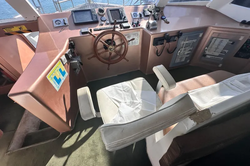  Yacht Photos Pics Cockpit of 2021 Jetcraft Passenger Boat with steering wheel and navigation equipment.