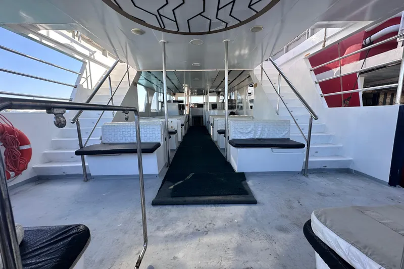  Yacht Photos Pics Spacious interior of 2021 Jetcraft passenger boat with seating and stairs.