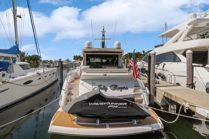 Jolly Rogers Yacht Photos Pics 2018 Sunseeker Predator 68 yacht docked with WaveRunner jet ski on deck.