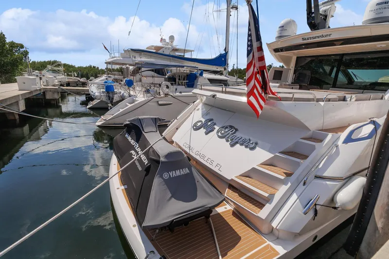 Jolly Rogers Yacht Photos Pics 2018 Sunseeker Predator 68 yacht docked with American flag, Yamaha equipment visible.