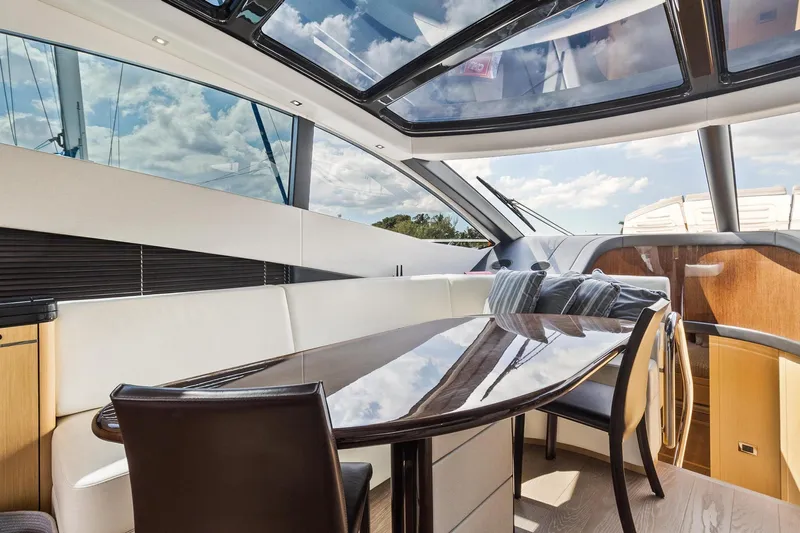 Jolly Rogers Yacht Photos Pics Luxurious interior of 2018 Sunseeker Predator 68 yacht with sleek dining area.