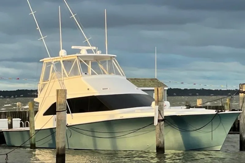 Offshore Obsession Yacht Photos Pics 1998 Ocean 53 Convertible yacht docked at a marina under cloudy skies.