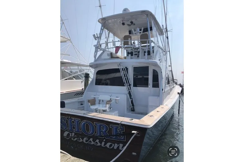 Offshore Obsession Yacht Photos Pics 1998 Ocean 53 Convertible yacht docked, featuring a spacious deck and flybridge.