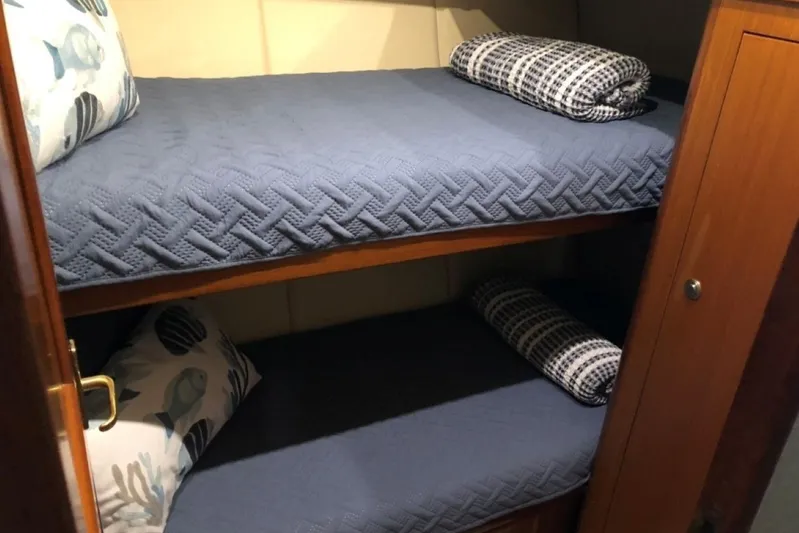 Offshore Obsession Yacht Photos Pics Bunk beds with blue bedding in a 1998 Ocean 53 Convertible yacht cabin.
