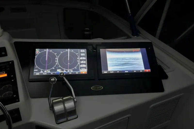 Offshore Obsession Yacht Photos Pics Cockpit of 1998 Ocean 53 Convertible with navigation and radar displays.