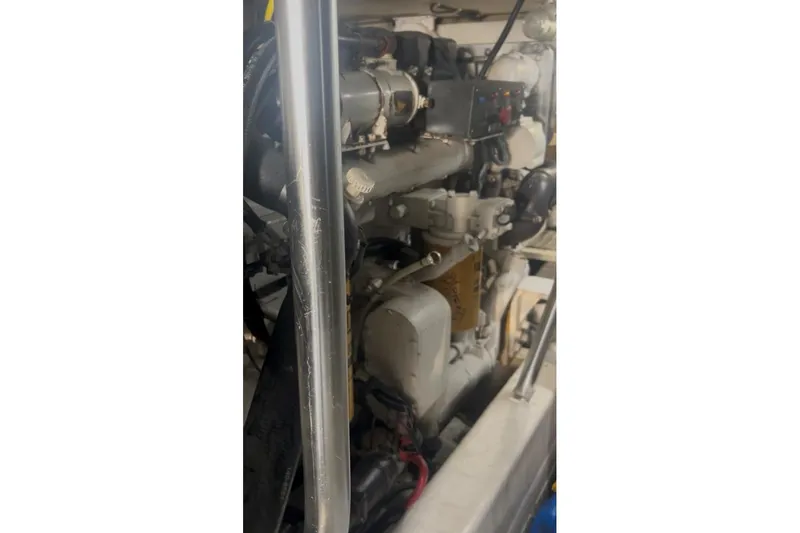 Offshore Obsession Yacht Photos Pics Engine compartment of a 1998 Ocean 53 Convertible yacht, showcasing mechanical components.