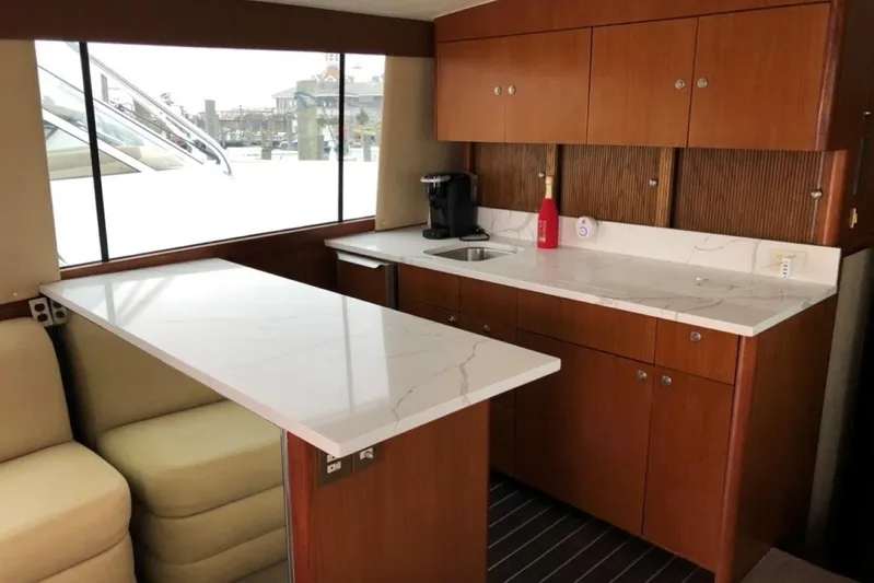 Offshore Obsession Yacht Photos Pics Luxurious interior of a 1998 Ocean 53 Convertible yacht with modern kitchen amenities.