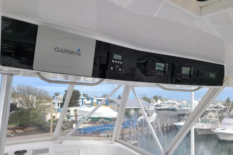 Offshore Obsession Yacht Photos Pics 1998 Ocean 53 Convertible yacht with Garmin navigation system, docked at marina.