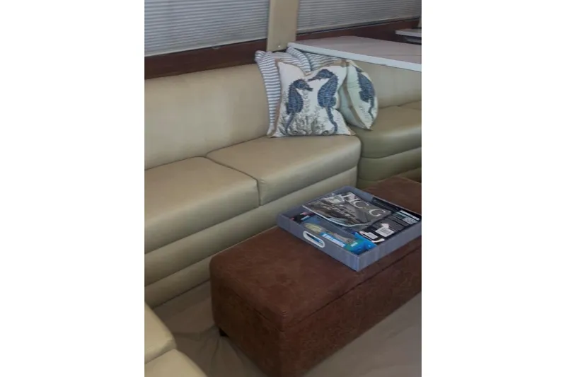Offshore Obsession Yacht Photos Pics Luxurious interior of 1998 Ocean 53 Convertible yacht with beige seating and decorative pillows.
