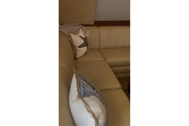 Offshore Obsession Yacht Photos Pics Luxurious beige seating with decorative pillows on a 1998 Ocean 53 Convertible yacht.