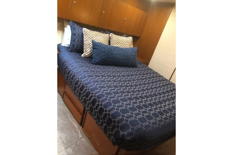 Offshore Obsession Yacht Photos Pics Luxurious bedroom interior of 1998 Ocean 53 Convertible yacht with geometric bedding.