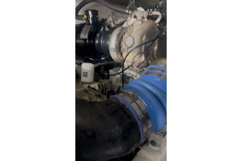 Offshore Obsession Yacht Photos Pics Engine compartment of a 1998 Ocean 53 Convertible yacht, featuring hoses and components.