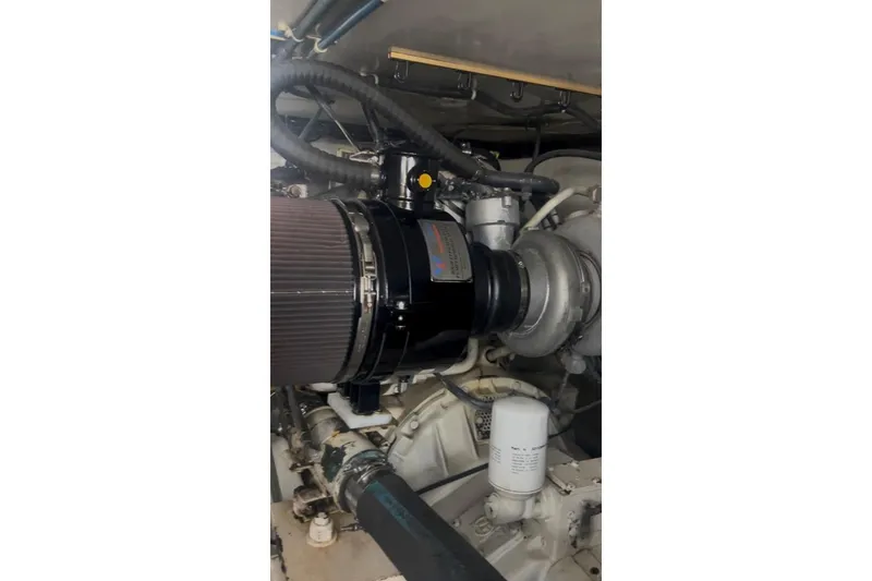 Offshore Obsession Yacht Photos Pics Engine compartment of a 1998 Ocean 53 Convertible yacht, showcasing mechanical components.