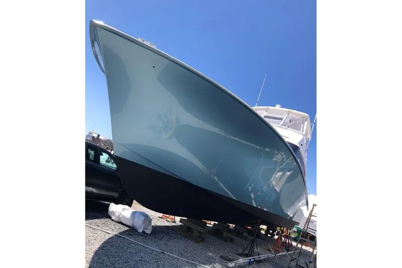 Offshore Obsession Yacht Photos Pics 1998 Ocean 53 Convertible yacht on dry dock under clear blue sky.