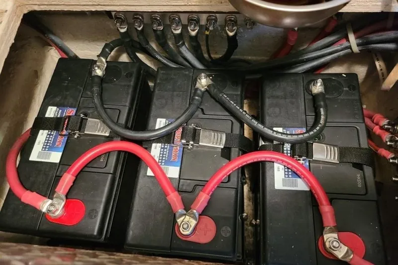 Offshore Obsession Yacht Photos Pics Battery compartment of a 1998 Ocean 53 Convertible boat with connected cables.