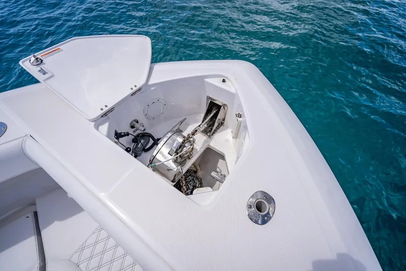  Yacht Photos Pics 2018 Everglades 435 Center Console anchor compartment with open hatch, on clear blue water.