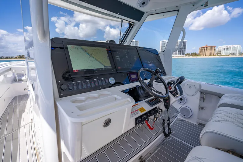  Yacht Photos Pics 2018 Everglades 435 Center Console boat cockpit with navigation screens and steering wheel.