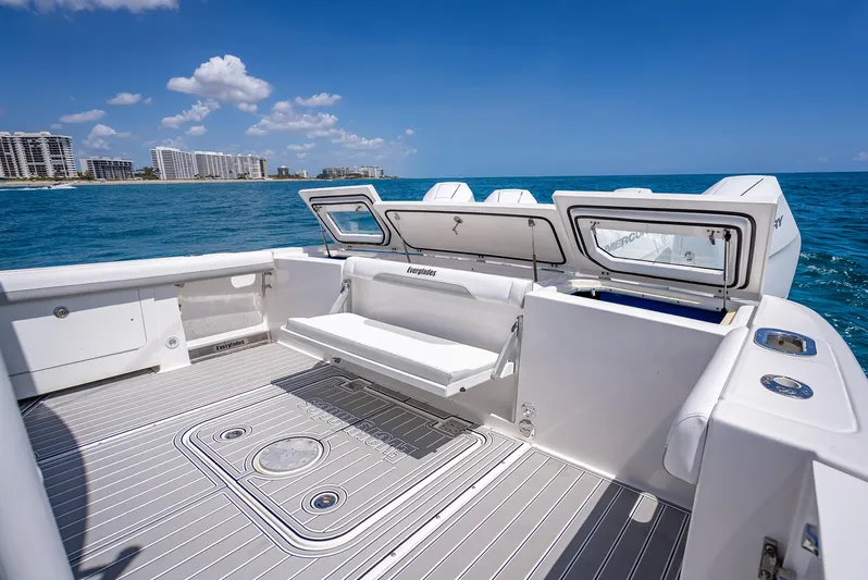  Yacht Photos Pics 2018 Everglades 435 Center Console boat on ocean, open deck, city skyline in background.