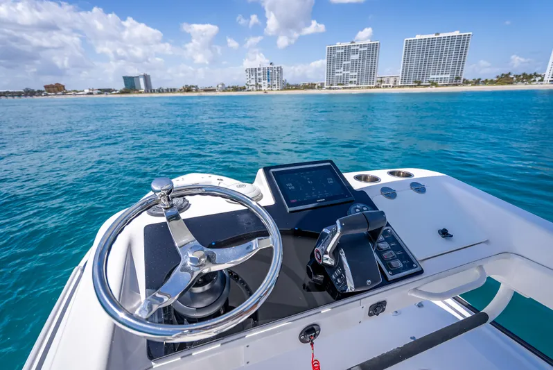  Yacht Photos Pics 2018 Everglades 435 Center Console boat dashboard with ocean and city skyline view.