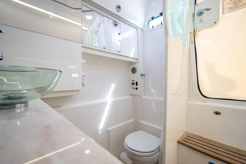  Yacht Photos Pics Luxurious 2018 Everglades 435 Center Console boat bathroom with modern fixtures and glass sink.