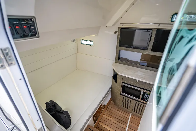 Yacht Photos Pics Interior of 2018 Everglades 435 Center Console with bed, TV, and microwave.