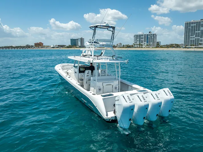  Yacht Photos Pics 2018 Everglades 435 Center Console boat on blue ocean near city skyline.