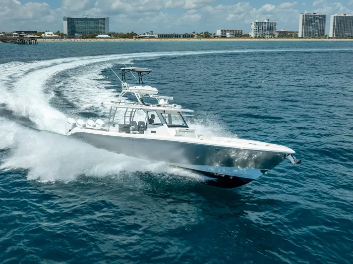  Yacht Photos Pics 2018 Everglades 435 Center Console boat cruising near coastline.