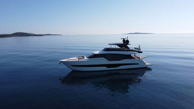 Victoria Yacht Photos Pics 2023 Cranchi Settantotto 78 yacht cruising on calm sea with distant islands.