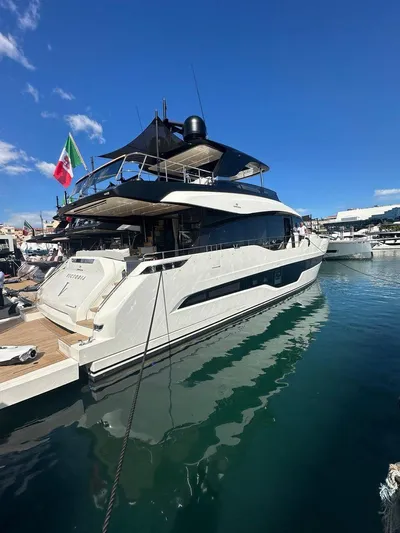 Victoria Yacht Photos Pics 2023 Cranchi Settantotto 78 yacht docked in a marina under a clear blue sky.