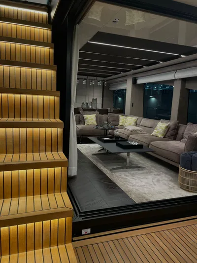 Victoria Yacht Photos Pics Luxurious interior of 2023 Cranchi Settantotto 78 yacht with elegant seating and illuminated stairs.
