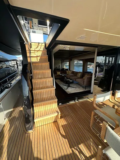 Victoria Yacht Photos Pics Luxurious 2023 Cranchi Settantotto 78 yacht interior with wooden stairs and elegant seating area.