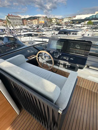 Victoria Yacht Photos Pics Luxurious helm of 2023 Cranchi Settantotto 78 yacht with modern controls and scenic marina view.