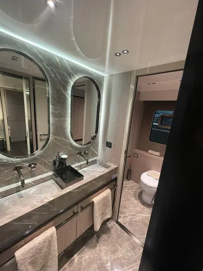 Victoria Yacht Photos Pics Luxurious bathroom in 2023 Cranchi Settantotto 78 yacht with marble finishes and modern fixtures.