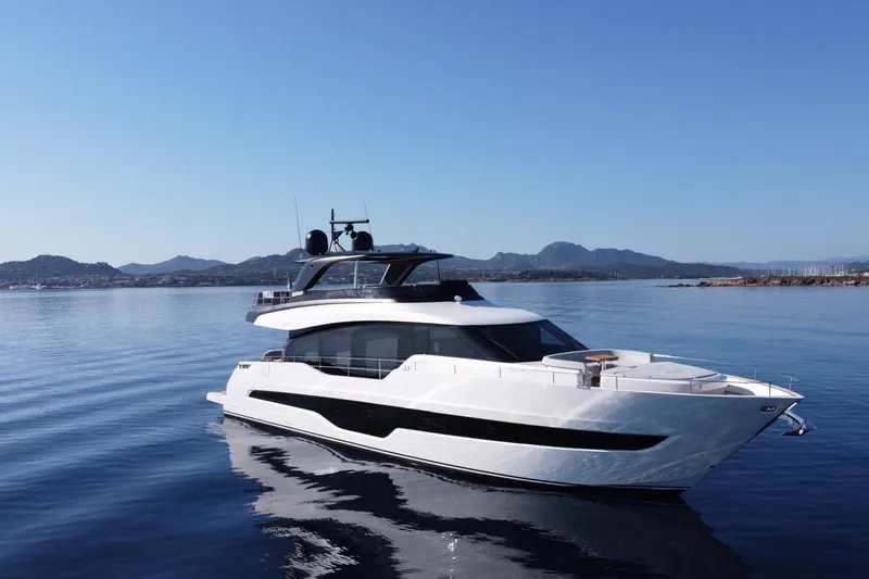 Victoria Yacht Photos Pics 2023 Cranchi Settantotto 78 yacht on calm water with scenic mountain backdrop.