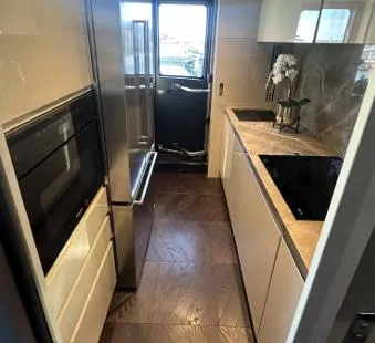 Victoria Yacht Photos Pics Modern kitchen interior of 2023 Cranchi Settantotto 78 yacht with sleek appliances and elegant design.