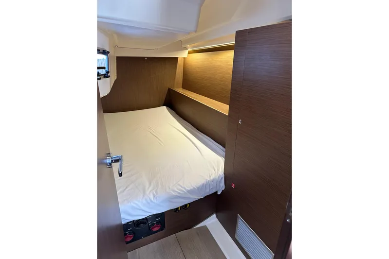 Claire Elise Yacht Photos Pics 2024 Beneteau Oceanis 37.1 cabin interior with cozy bed and wooden finish.